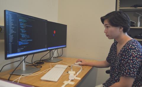 Annika Pfister, an REU participant who is a rising senior at Wellesley College in Massachusetts, is participating in research this summer in the lab of UW ECE Assistant Professor Sam Burden. Photo by Eric Chudler / Center for Neurotechnology Annika Pfister working at a computer
