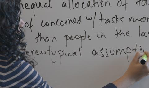Theater for Change UW uses interactive theater to highlight instances of discrimination and oppression underrepresented students commonly face. Above, Debi Talukdar, Theater for Change UW program coordinator and facilitator, writes audience feedback on a whiteboard during the CNT workshop. A woman writes text on a whiteboard