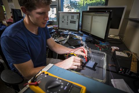 CNT student member, David Caldwell, working on an electrocorticographic (ECoG) grid in the lab