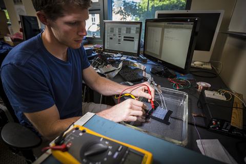 CNT student member, David Caldwell, working on an electrocorticographic (ECoG) grid in the lab CNT student member, David Caldwell, working on an electrocorticographic (ECoG) grid in the lab