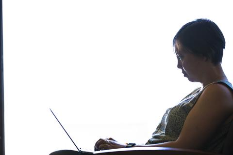A woman sitting at a laptop computer