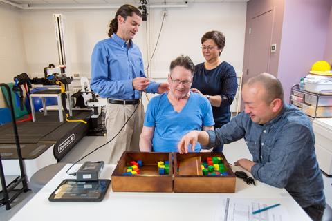 CNT Co-Director, Chet Moritz (left), and CNT-funded graduate students, Fatma Inanici and Soshi Samejima, work on motor skill tasks with study participant Joe Beatty (center) in the UW AMP Lab. These tasks help test the effectiveness of transcutaneous spinal stimulation when combined with physical therapy.