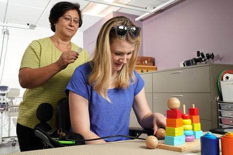 Jessie Owen (right), who has a spinal cord injury, spoke at the Spring 2021 CNT End-user Roundtable about her decision to participate in a CNT research study. Owen described what the experience was like for her and how neurotechnology has impacted her life. In this photo, CNT researcher Dr. Fatma Inanici is applying small patches that will deliver electrical currents on the surface of the skin, over the injured area in Owen’s neck. This electrical stimulation helps the brain to reestablish connections with nerves in the spinal cord. This photo was taken in 2018 by Marcus Donner. Dr. Fatma Inanici applies an electrified patch to the neck of CNT study participant Jessie Owen