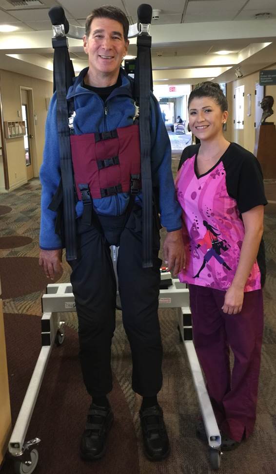 Gendler takes a break with caregiver Devon during a recent physical therapy session. 