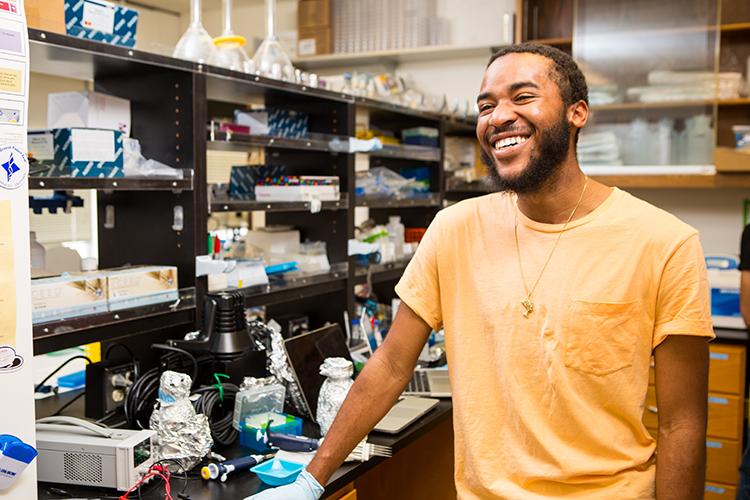 Jesse Woodbury, smiling, in Dr. Saigal's lab