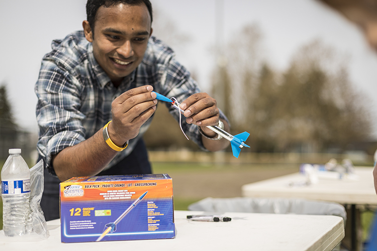 Gaurav Mukherjee fixing a rocket at a NESSP event