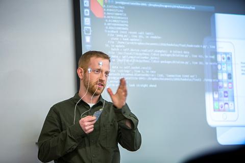 Team leader, Jared Calleham, demonstrates Hawkulus, a wearable device for controlling a smartphone with eye movements.