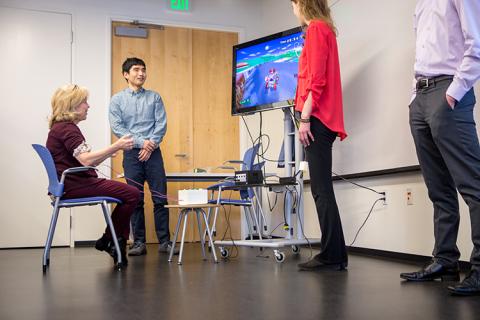 Kim Emmons from the Washington Research Foundation gives AEGIS a try. This accessible gaming system uses EMG signals from muscle groups (like Emmon's forearms) to control a Mario Kart video game.